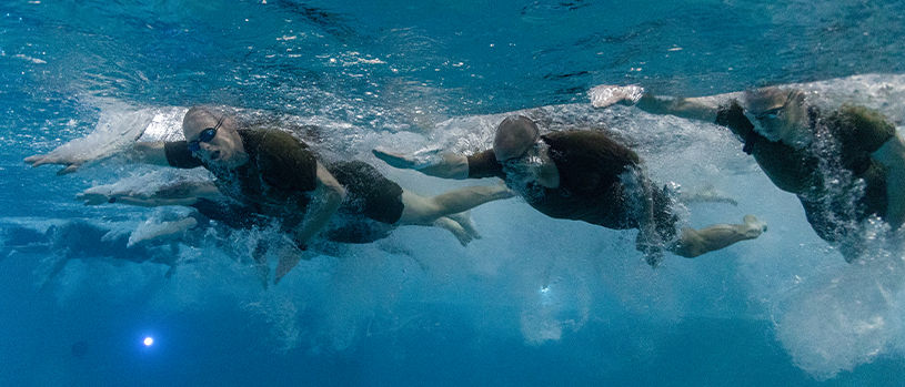 Marines conducting underwater combat training and swimming drills.