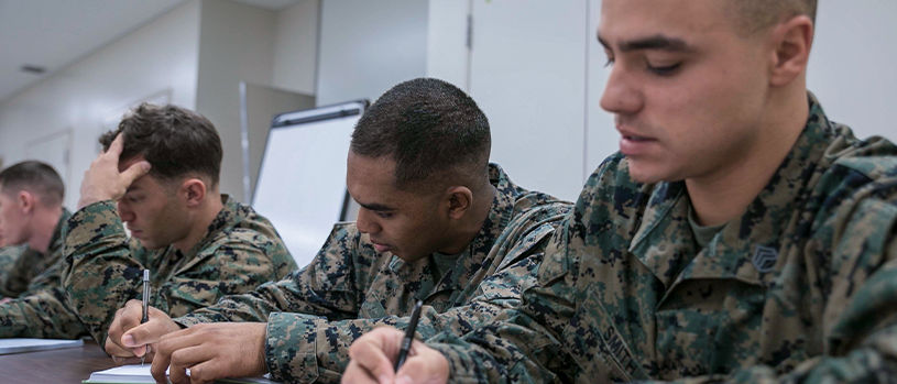 Marines taking written exam in classroom during special operations training.