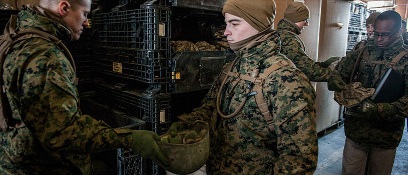 Officer candidates organize gear and equipment in storage racks during Phase 1 training at Officer Candidates School.