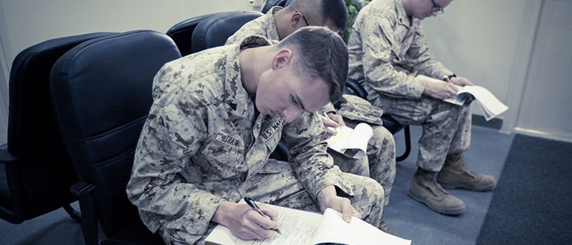 Marines receiving medical care and health services at military healthcare facility during appointment.
