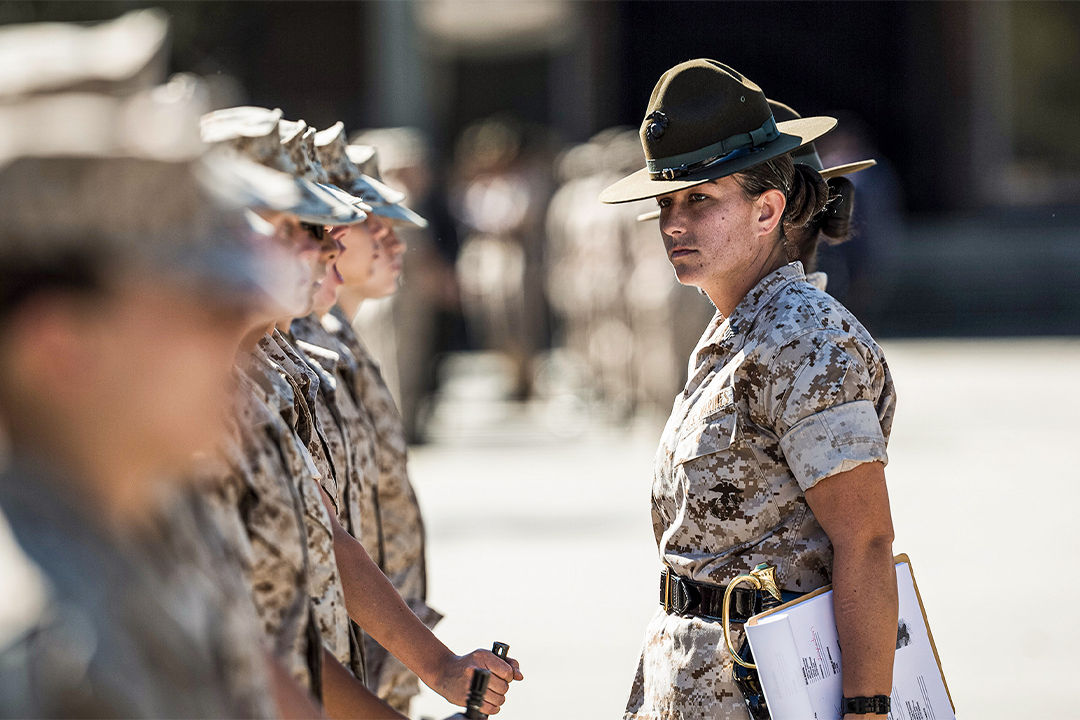 Female Marine drill instructor in campaign cover and desert camouflage conducting recruit training at Parris Island.