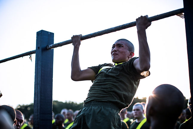 Marine doing pull ups as part of a Physical Fitness Test.