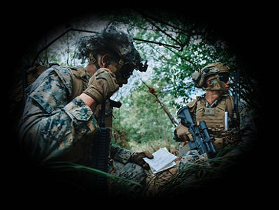 Two U.S. Marines using communication devices