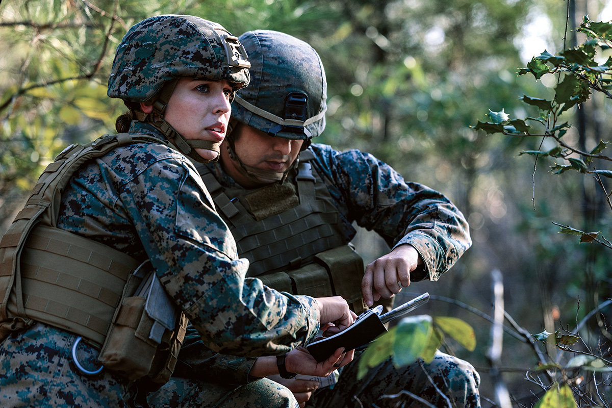 First Lieutenant Annie Parnell reviews tablet with fellow Marine during cyber operations training exercise at Camp Lejeune.