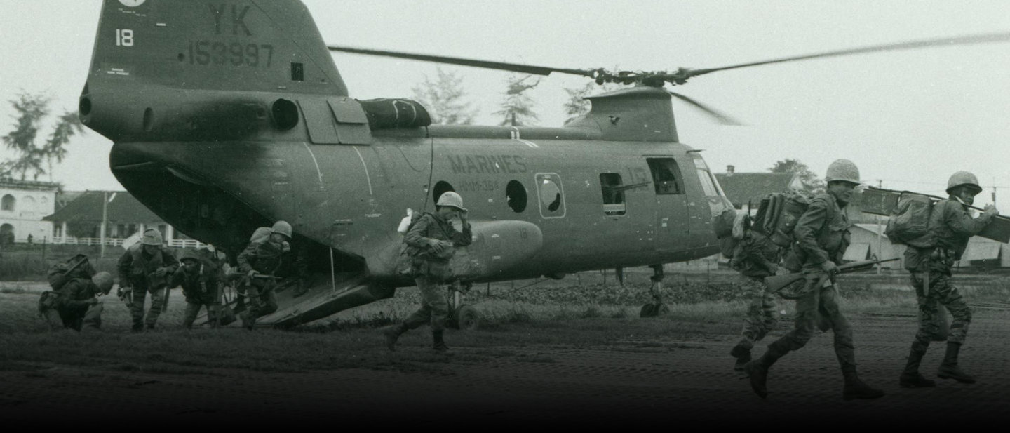 Historical photo of Marines evacuating wounded soldier to helicopter during Battle of Hue in Vietnam War 1968.