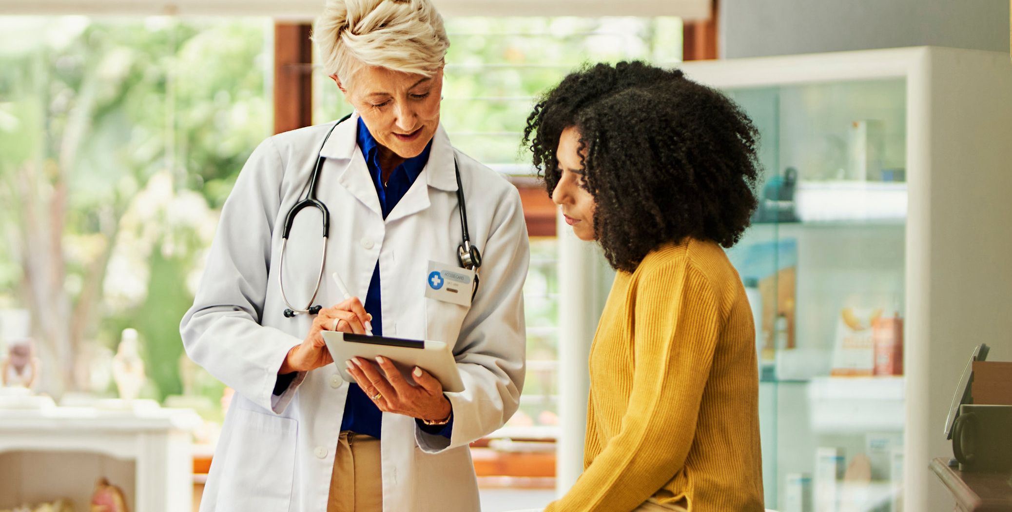 Mother and daughter talking to doctor.