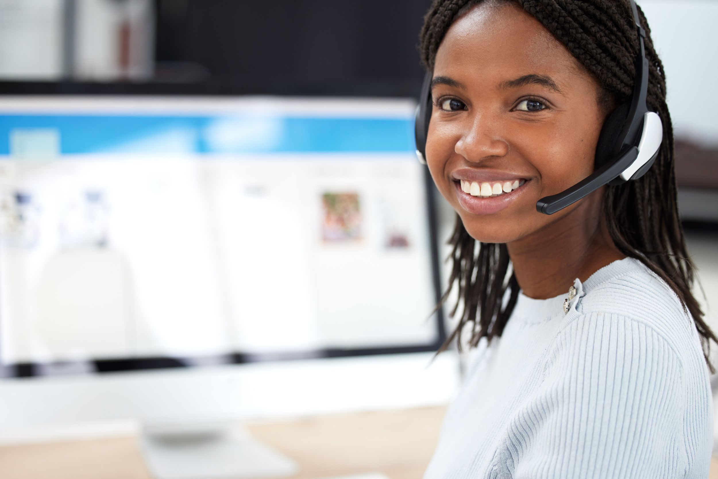 portrait of black woman with computer in office. Contact us, crm and face of happy female sales agent, telemarketing or help desk worker 