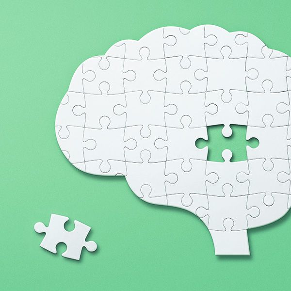 Puzzle in the shape of a brain with a missing piece