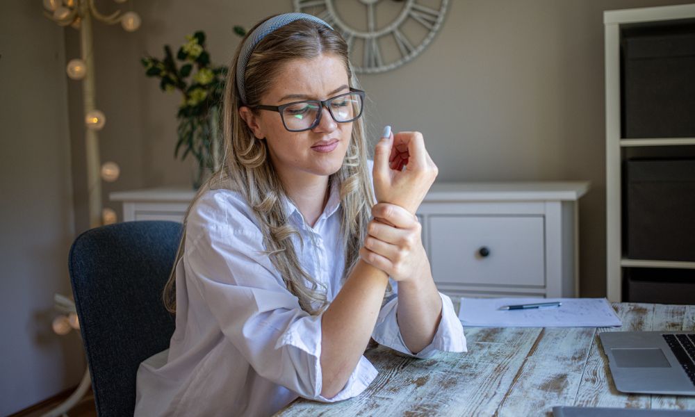 Female holding wrist