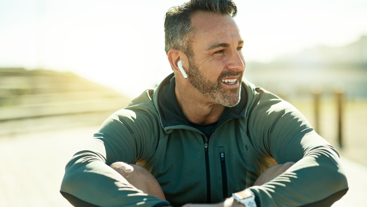 Man sitting with workout clothes on and airpods