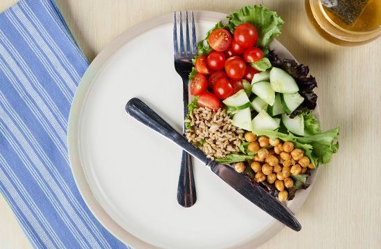 Food portioned on a plate with knife and fork