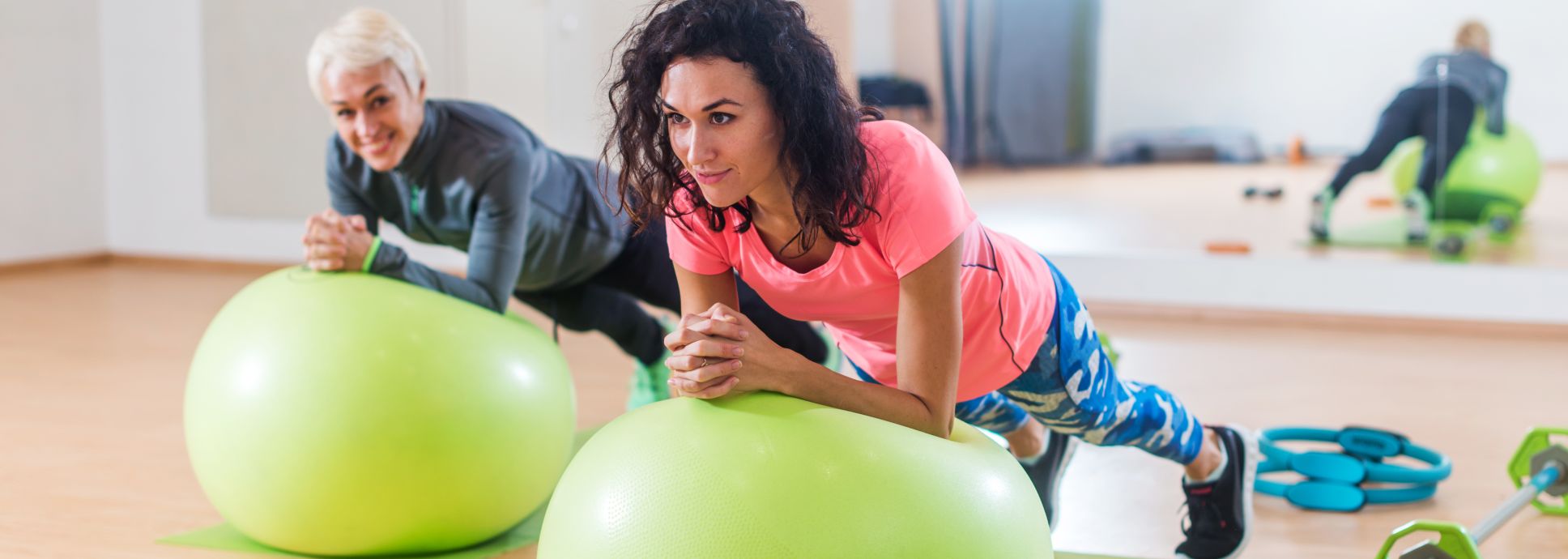 2 women working out with exercise balls
