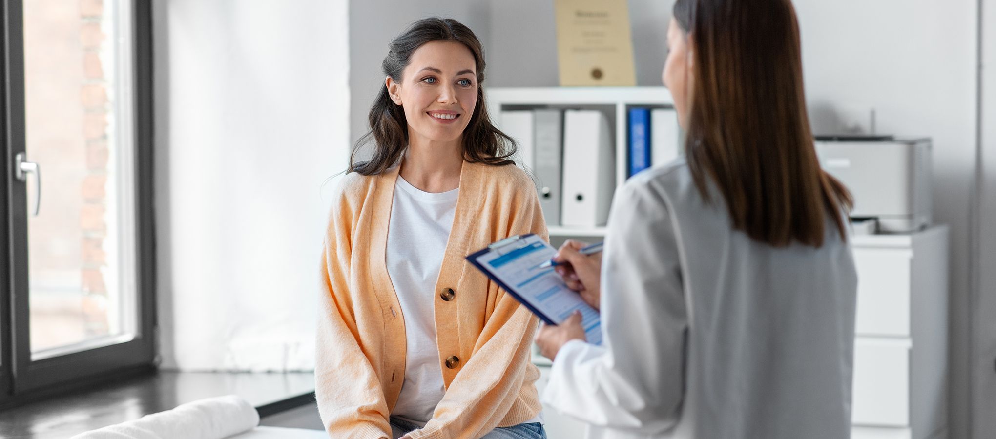 female patient talking to female physician