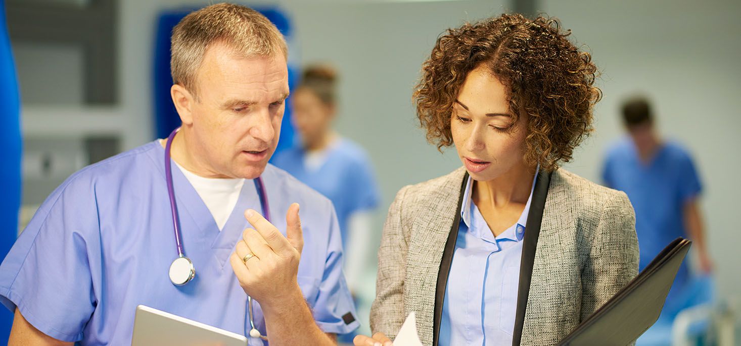 Doctor and lab consultant discussing lab