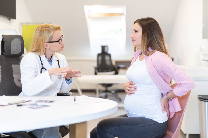 Pregnant woman talking to doctor