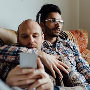Men embracing on couch