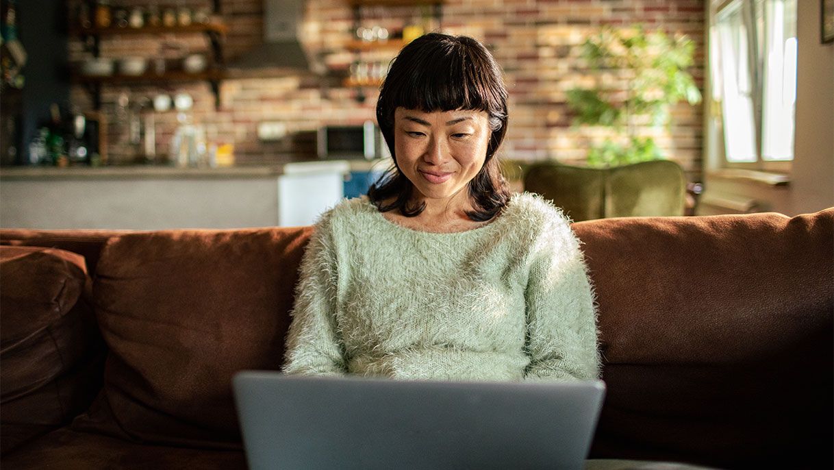 Woman sitting on the couch on her laptop