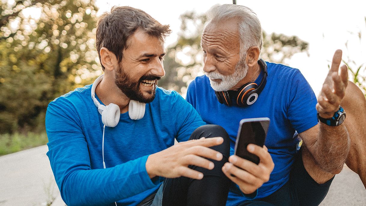 2 men hiking looking at their phone 