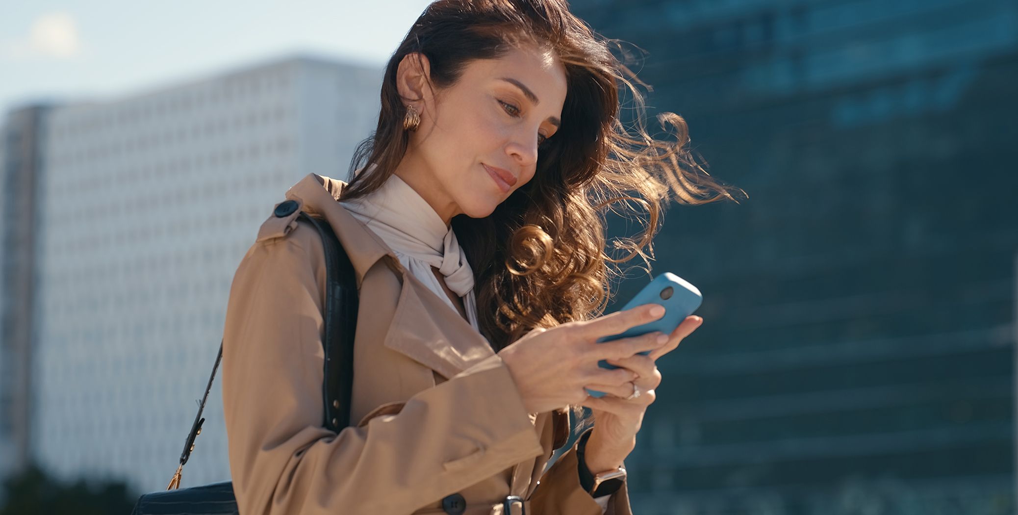 Woman typing on her cell phone