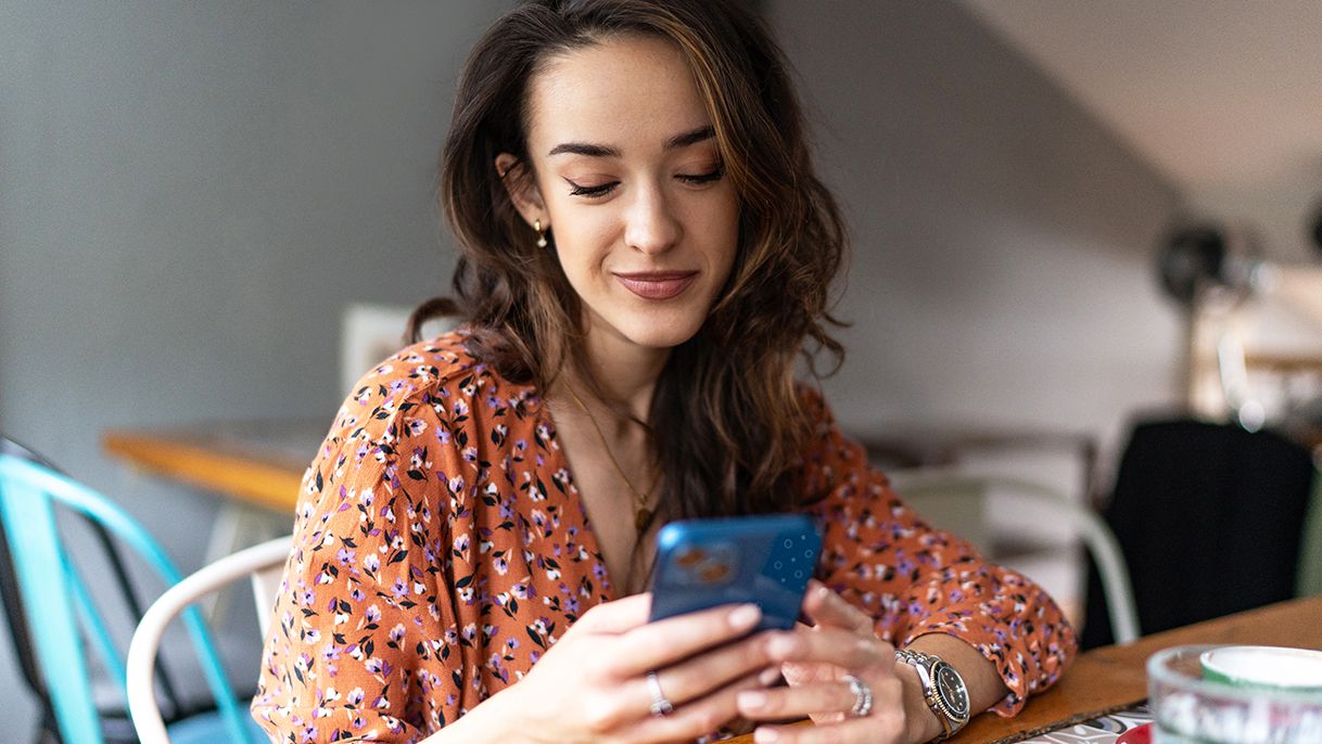 Woman typing on her cell phone