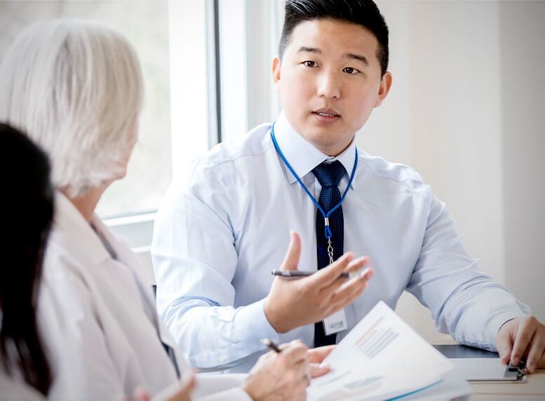 man talking with others