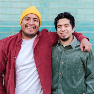 Two men standing shoulder to shoulder