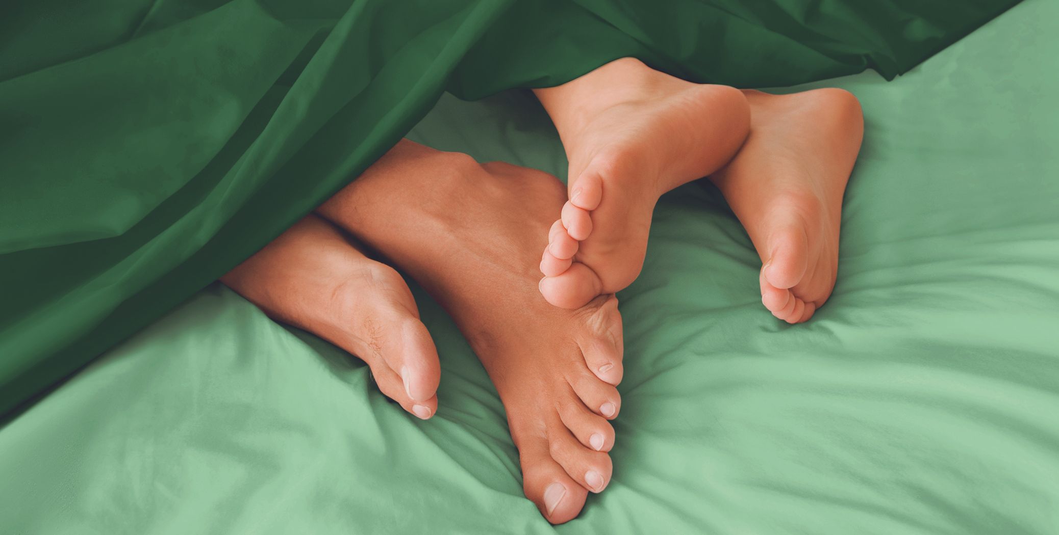 Couple in bed, feet showing under covers