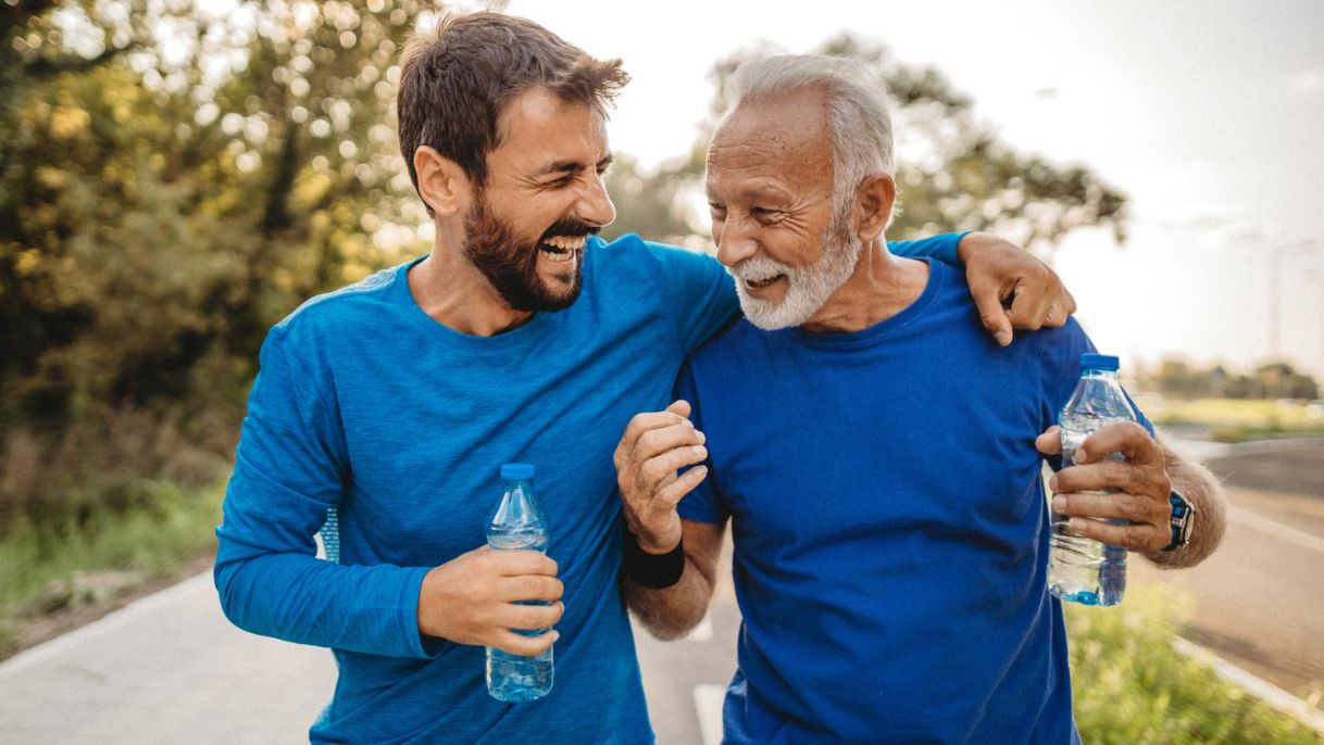 Father and son on a walk holding water bottles 