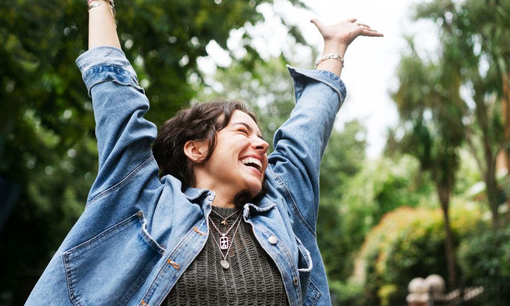 woman excited with hands in air