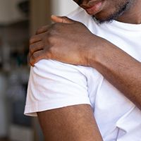 Man holding his shoulder in pain