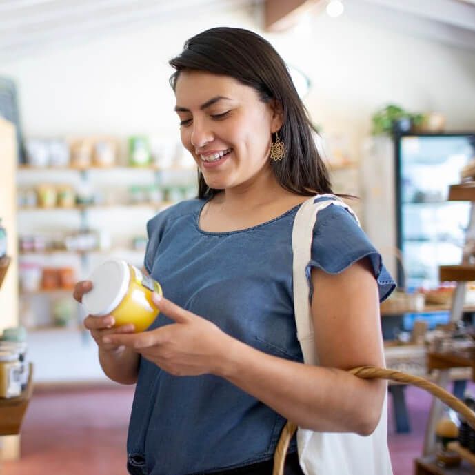 Woman looking at a jar in a shop