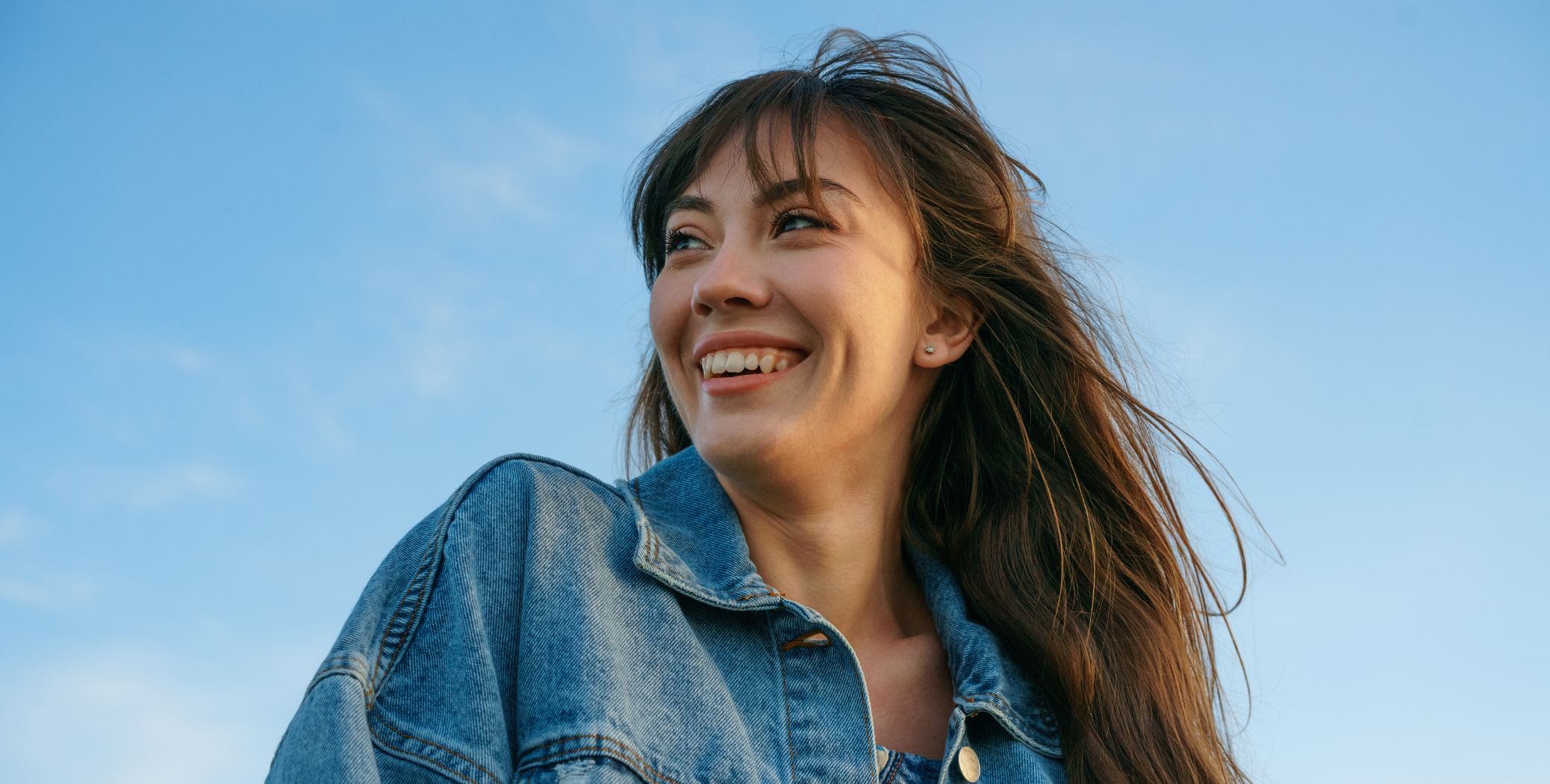 woman smiling with blue sky