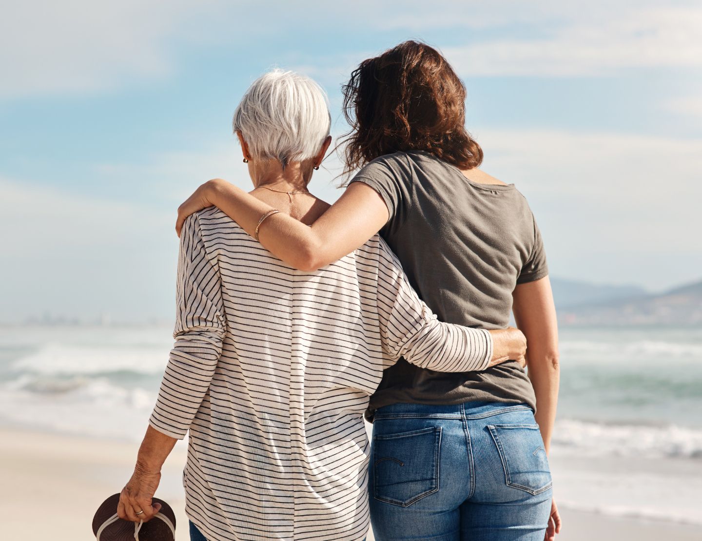 mother and daughter walking on beach