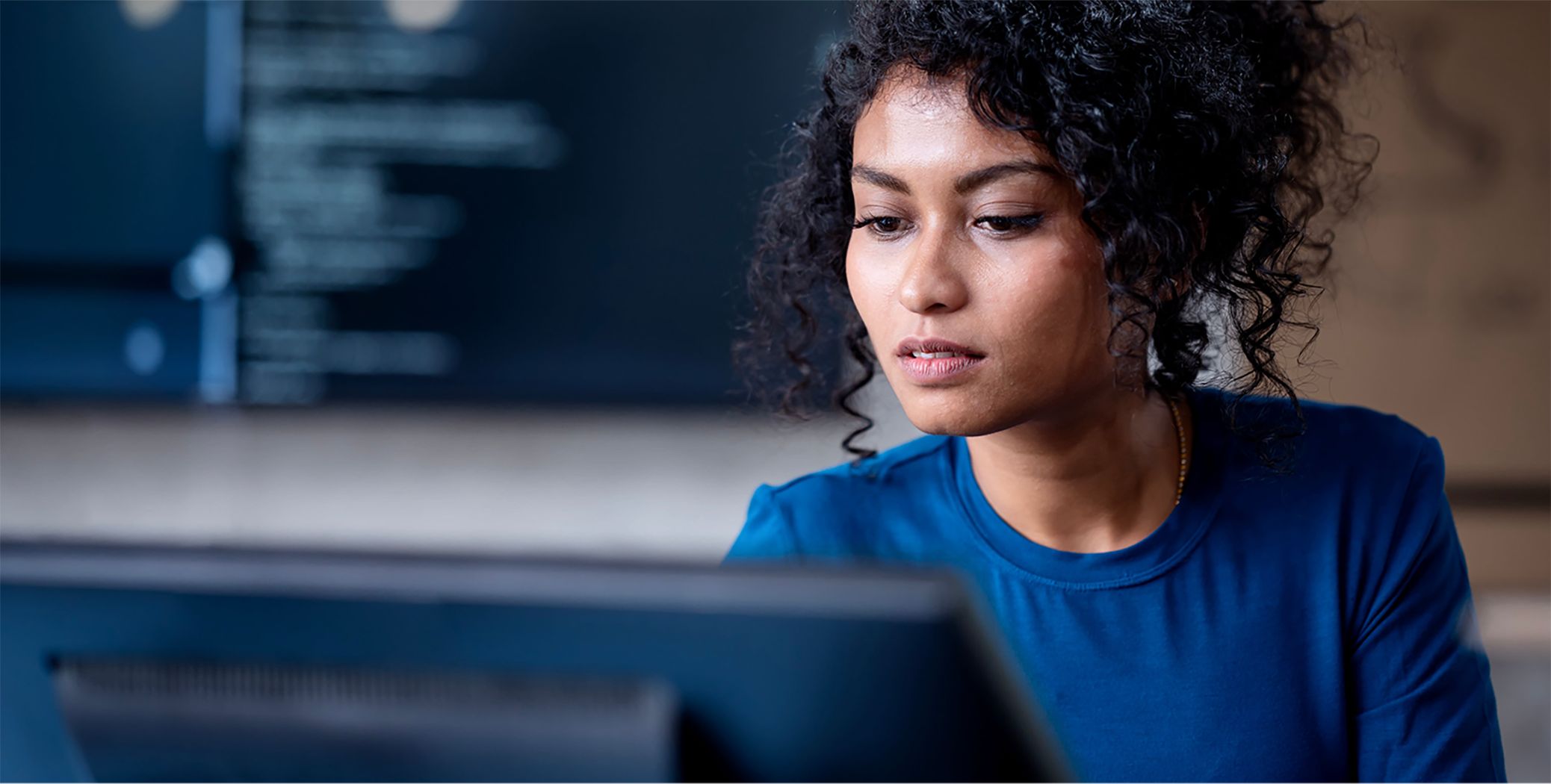 Image of woman looking at computer