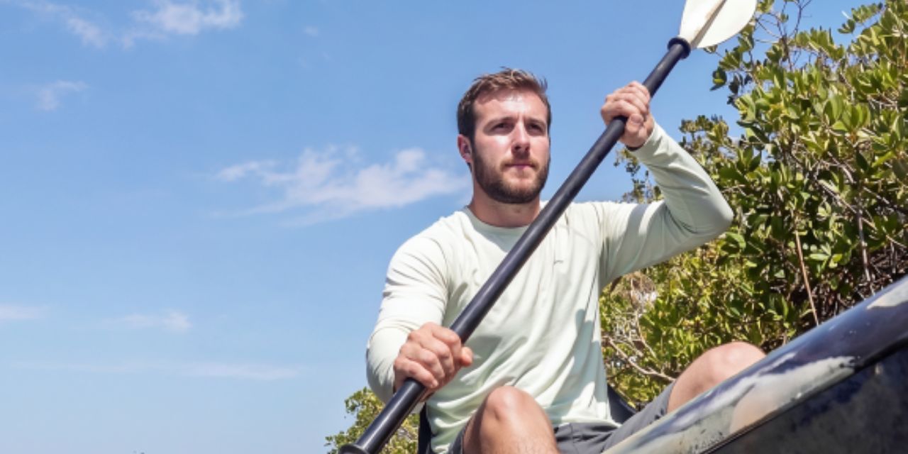 man rowing in kayak