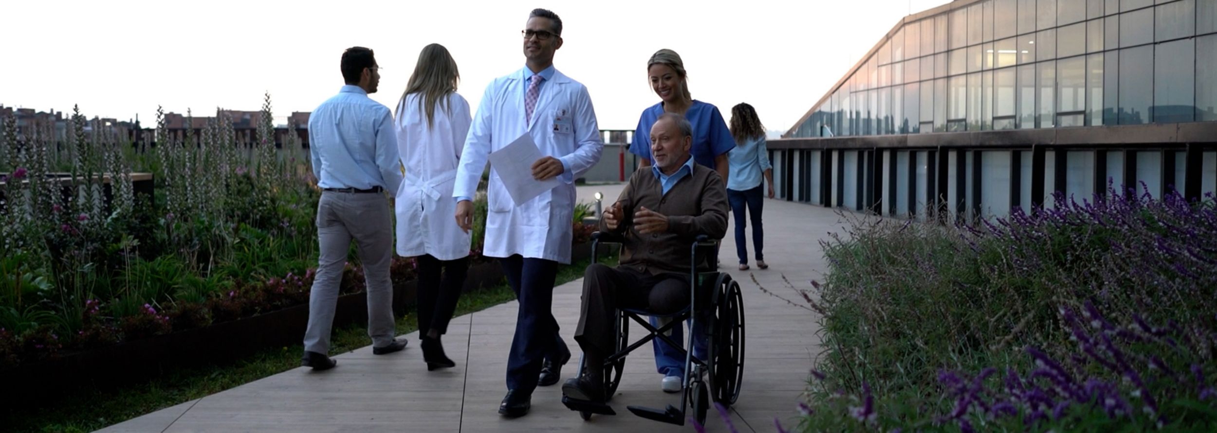 Care team with patient in a wheelchair