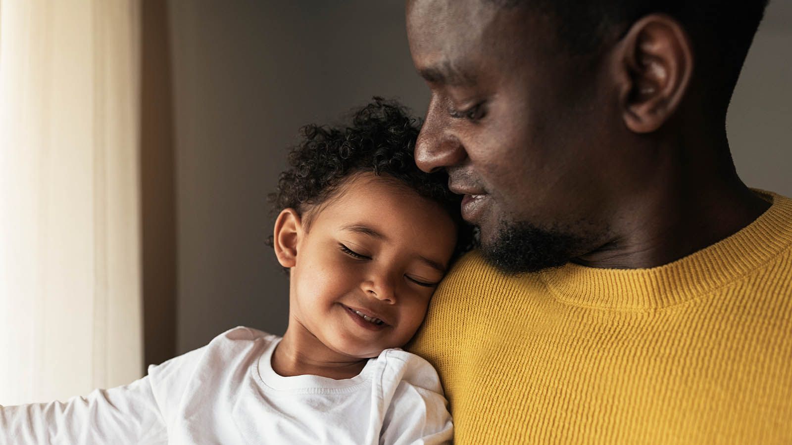 Man holding a sleeping child