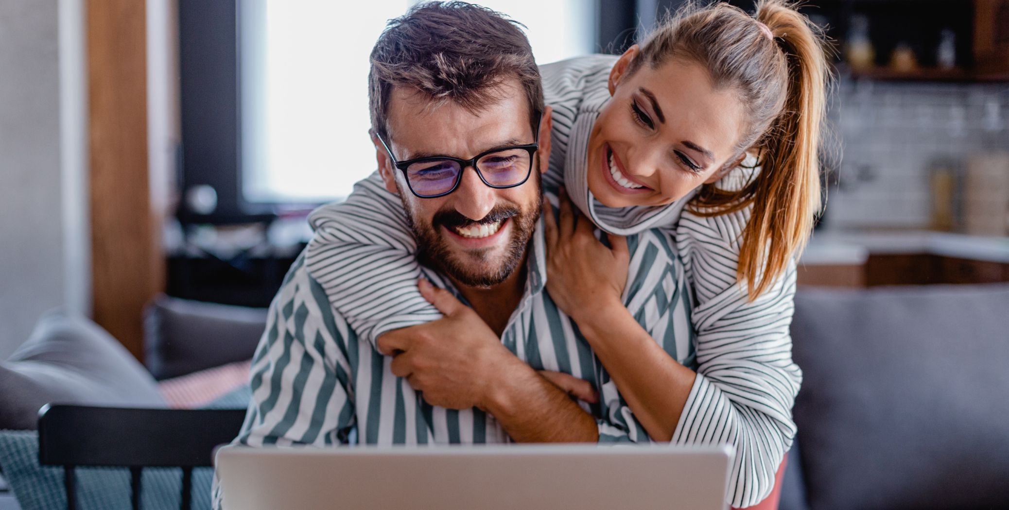 Couple sitting at a table on a laptop