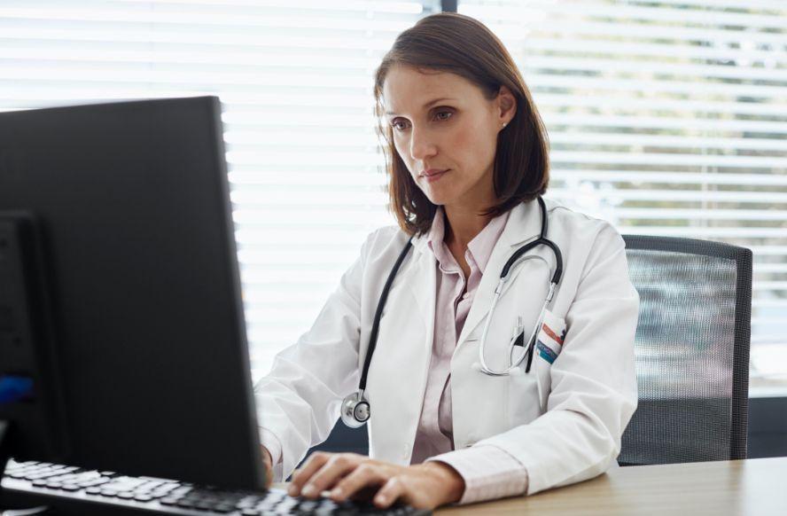 female doctor on computer